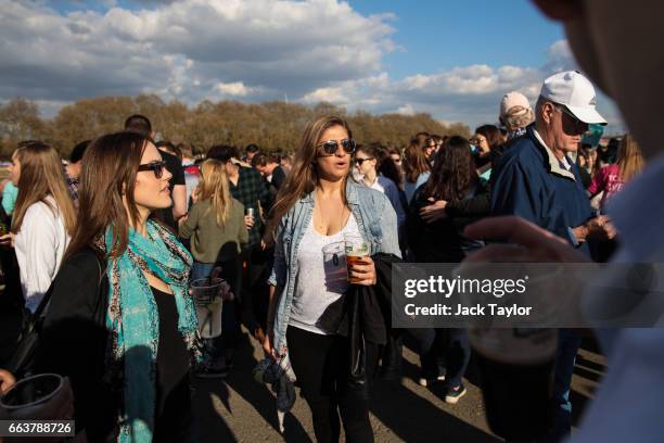 Spectators gather during the annual Boat Race between Oxford and Cambridge University along the River Thames in Putney on April 2, 2017 in London,...