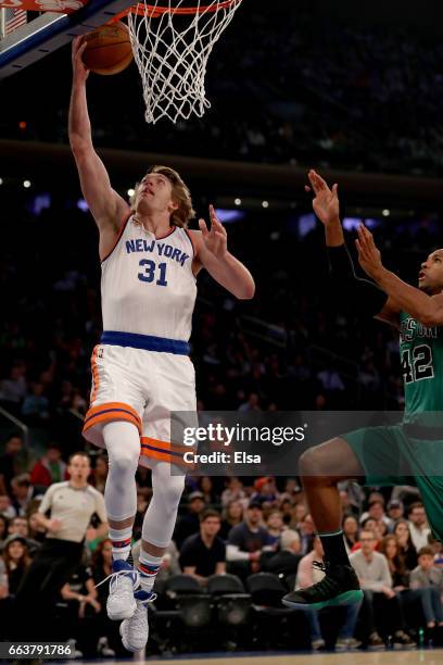 Ron Baker of the New York Knicks heads for the net sa Al Horford of the Boston Celtics defends at Madison Square Garden on April 2, 2017 in New York...