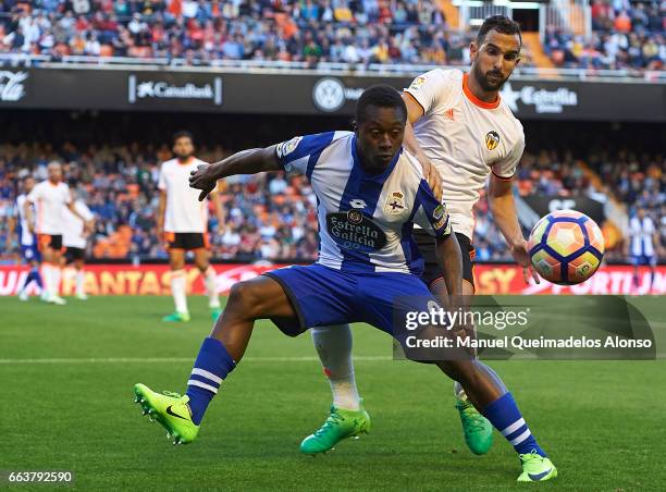 Martin Montoya of Valencia competes for the ball with Marlos Moreno of Deportivo de La Coruna during the La Liga match between Valencia CF and...