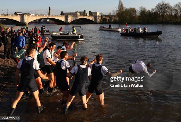 The Oxford men's crew celebrate winning the Cancer Research UK Boat Race by throwing Samuel Collier, cox of The Oxford men's crew into the river on...