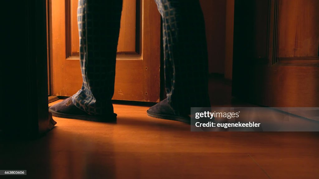 Adult man walks to a bathroom at the night