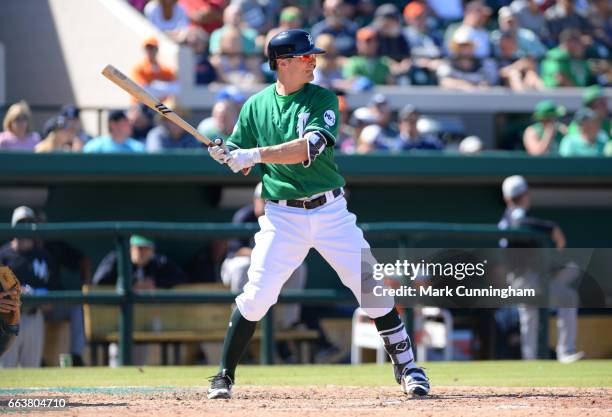 Brendan Ryan of the Detroit Tigers bats while wearing a green jersey and hat to honor St. Patricks Day during the Spring Training game against the...