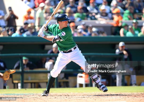 Brendan Ryan of the Detroit Tigers bats while wearing a green jersey and hat to honor St. Patricks Day during the Spring Training game against the...