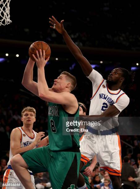 Jonas Jerebko of the Boston Celtics heads for the net as Maurice Ndour of the New York Knicks defends at Madison Square Garden on April 2, 2017 in...