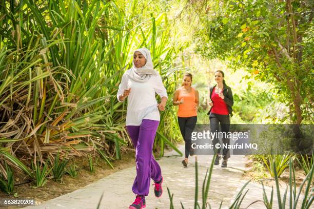 girls jogging in outdoor - dubai fitness stock pictures, royalty-free photos & images