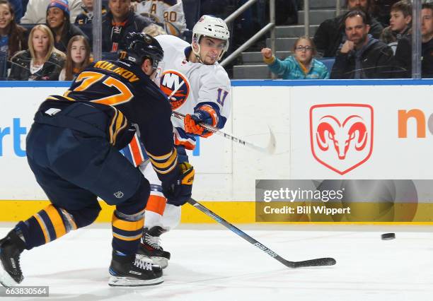 Shane Prince of the New York Islanders shoots against Dmitry Kulikov of the Buffalo Sabres during an NHL game at the KeyBank Center on April 2, 2017...