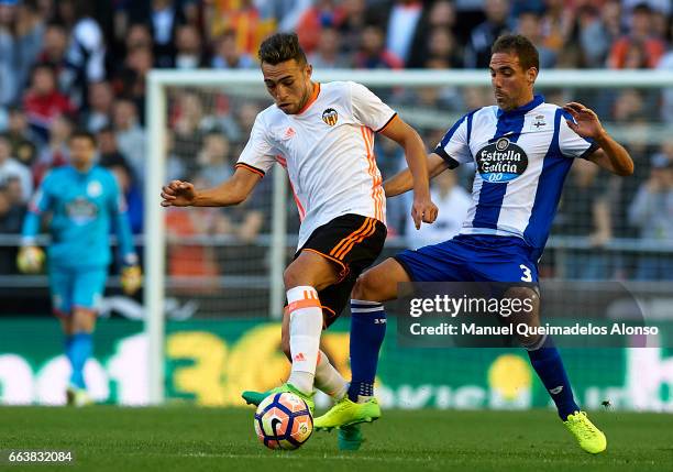 Munir El Haddadi of Valencia is tackled by Fernando Navarro of Deportivo de La Coruna during the La Liga match between Valencia CF and Deportivo de...