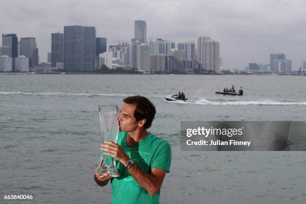 Roger Federer of Switzerland kisses the trophy in front of the Miami skyline after defeating Rafael Nadal of Spain in the final at The Rusty Pelican...