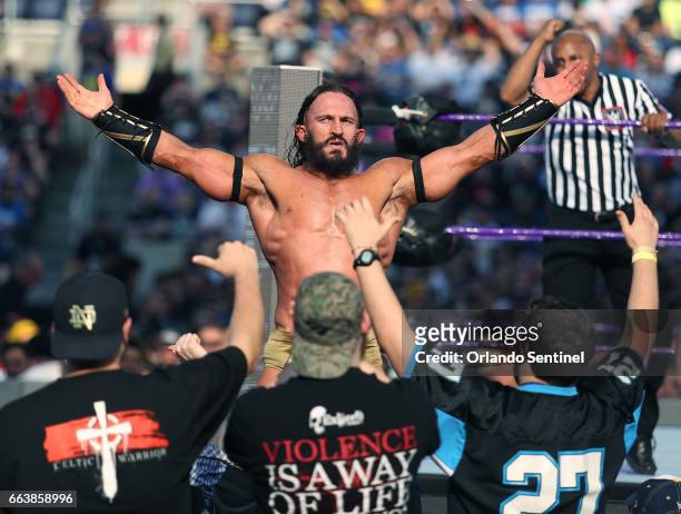 Adrian Neville celebrates with fans during WrestleMania 33 on Sunday, April 2, 2017 at Camping World Stadium in Orlando, Fla.