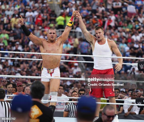 Wrestler Mojo Rawley, left, and New England Patriots tight end Rob Gronkowski, right, celebrate in the ring during WrestleMania 33 on Sunday, April...