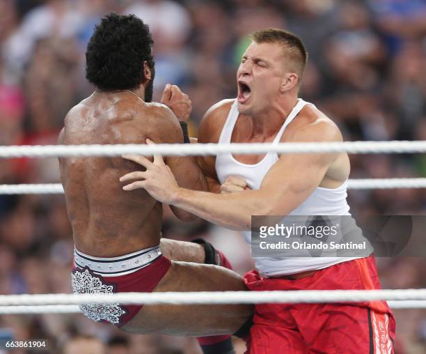 New England Patriots tight end Rob Gronkowski, right, screams as he hits wrestler Jinder Mahal, left, in the ring during WrestleMania 33 on Sunday,...