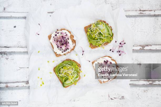 healthy whole grain bread with different toppings - spread stock-fotos und bilder
