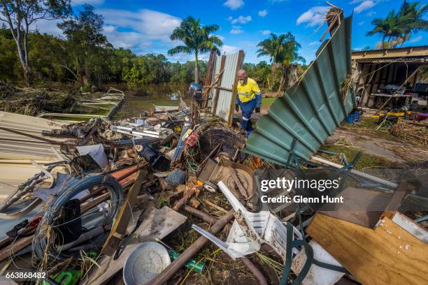 Volunteer Tim Mainwaring helps clean up a property at Eagleby that was damaged by flood water on April 3, 2017 in Eagleby, Australia. Heavy rain...