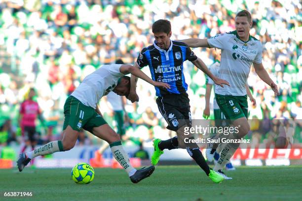 Ulises Davila of Santos fights for the ball with Juan Forlin of Queretaro during the 12th round match between Santos Laguna and Queretaro as part of...