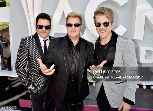 Recording artists Jay DeMarcus, Gary LeVox and Joe Don Rooney of Rascal Flatts attend the 52nd Academy Of Country Music Awards at Toshiba Plaza on...