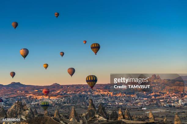 hot air balloon flying over spectacular cappadocia. - cappadocia stock pictures, royalty-free photos & images