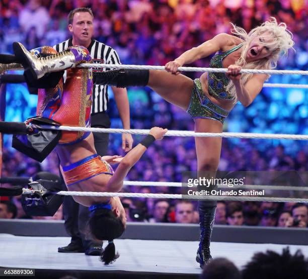 Charlotte Flair, right, kicks Bayley during WrestleMania 33 on Sunday, April 2, 2017 at Camping World Stadium in Orlando, Fla.