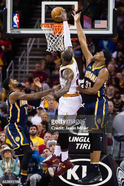 Paul George and Myles Turner of the Indiana Pacers try to stop LeBron James of the Cleveland Cavaliers during the first half at Quicken Loans Arena...