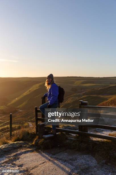 a young woman walks over a stile at sunrise in the peak district national park, england. - stye stock pictures, royalty-free photos & images