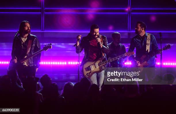 Bassist Geoff Sprung, frontman Matthew Ramsey, drummer Whit Sellers, and guitarist Brad Tursi of music group Old Dominion perform onstage during the...
