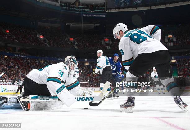 April 2: Justin Braun Mikkel Boedker of the San Jose Sharks and Michael Chaput of the Vancouver Canucks look on as Martin Jones of the San Jose...