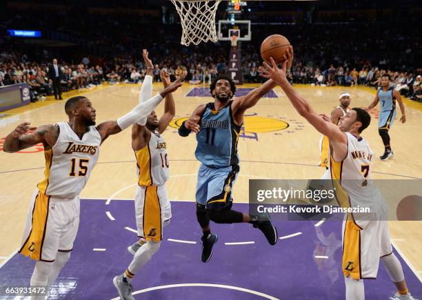 Mike Conley of the Memphis Grizzlies scores a basket against Thomas Robinson Tyler Ennis Larry Nance Jr. #7 of the Los Angeles Lakers during the...