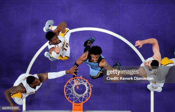 Mike Conley of the Memphis Grizzlies scores a basket against Thomas Robinson Tyler Ennis Larry Nance Jr. #7 of the Los Angeles Lakers during the...