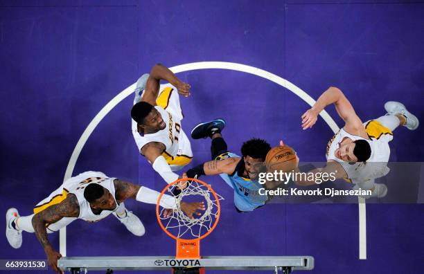 Mike Conley of the Memphis Grizzlies scores a basket against Thomas Robinson Tyler Ennis Larry Nance Jr. #7 of the Los Angeles Lakers during the...
