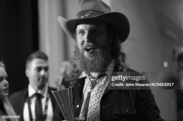 Singer John Osborne of Brothers Osborne poses with the Vocal Duo of the Year award backstage during the 52nd Academy Of Country Music Awards at...