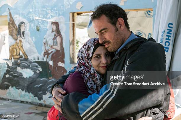 At the Moria Camp in Lesbos, Greece, refugee couple Samir Lawawd and his wife Samira from Syria wait to be registered by the authorities so they can...