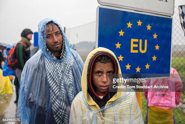 In freezing cold and heavy rain refugees wait to cross at the Timovec border crossing between Croatia and Slovenia.