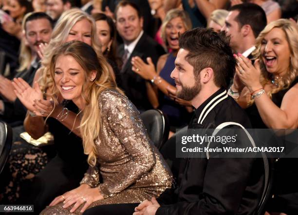 Lauren Gregory and singer-songwriter Thomas Rhett react during the 52nd Academy Of Country Music Awards at T-Mobile Arena on April 2, 2017 in Las...