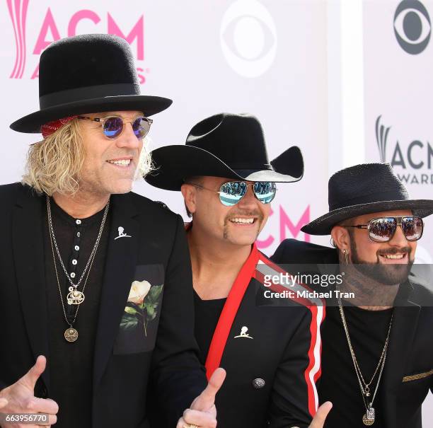 Big Kenny and John Rich of music group Big & Rich, and DJ Sinister arrive at the 52nd Academy of Country Music Awards held at T-Mobile Arena on April...