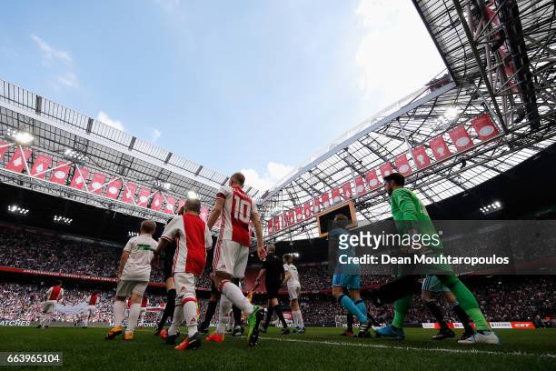 Captains, Davy Klaassen of Ajax and Dirk Kuyt of Feyenoord Rotterdam walk out to play the Dutch Eredivisie match between Ajax Amsterdam and Feyenoord...
