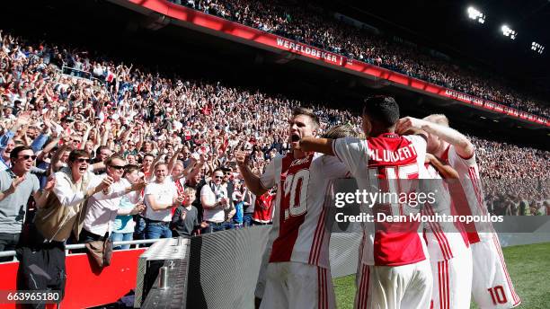 David Neres of Ajax celebrates scoring his teams second goal of the game with team mates during the Dutch Eredivisie match between Ajax Amsterdam and...