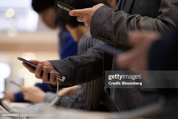 Customers try out Samsung Electronics Co. Galaxy S8 smartphones at the company's D'light flagship store in Seoul, South Korea, on Monday, April 3,...