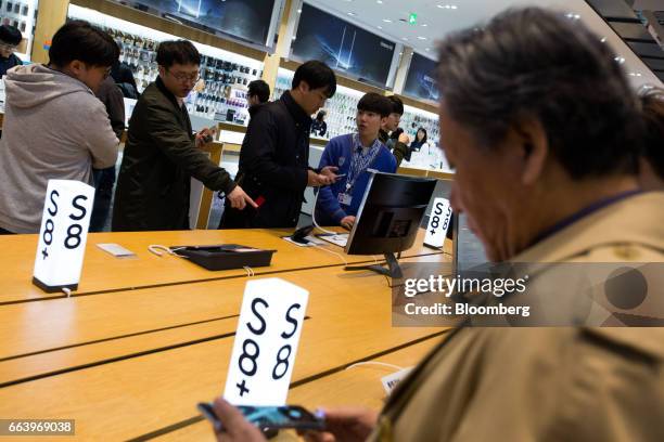 Customers try out Samsung Electronics Co. Galaxy S8 smartphones at the company's D'light flagship store in Seoul, South Korea, on Monday, April 3,...