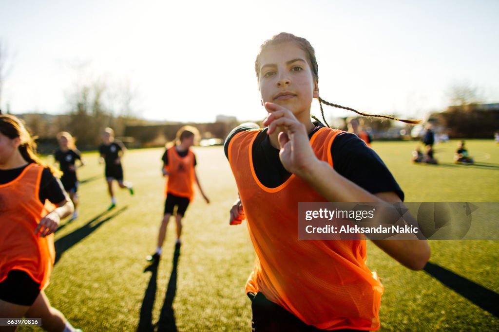 Female soccer player and her team