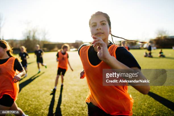 female soccer player and her team - teenage girls stock pictures, royalty-free photos & images