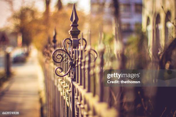 old metal fence in urban area, germany - variable schärfentiefe fotografías e imágenes de stock