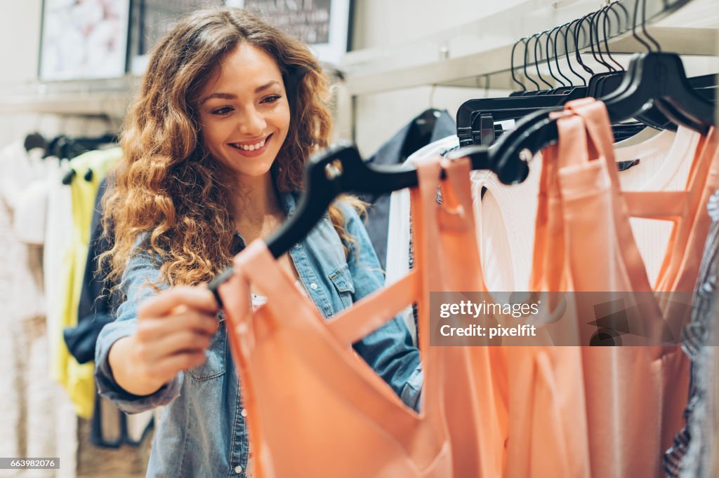 Young woman browsing in the fashion store