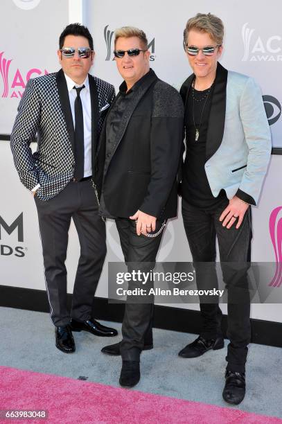 Recording artists Jay DeMarcus, Gary LeVox, and Joe Don Rooney of music group Rascal Flatts arrive at the 52nd Academy Of Country Music Awards on...