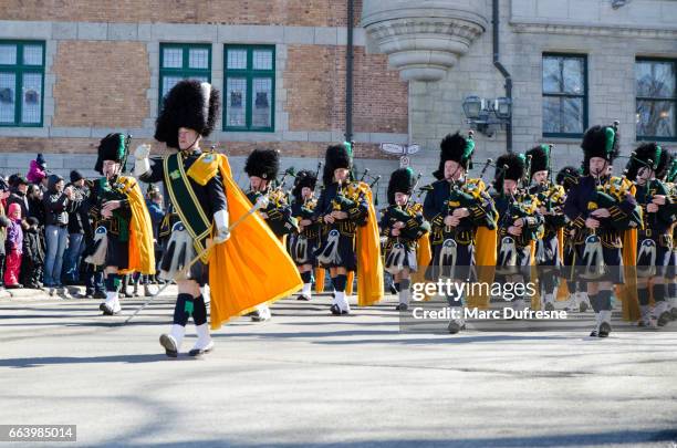 marching band of the new york police department with bagpipes at the quebec st-patrick's parade - woman kilt stock pictures, royalty-free photos & images