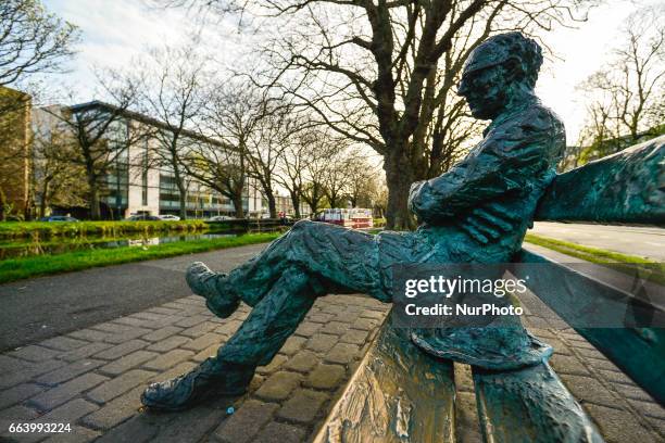 View of the statue of Patrick Kavanagh on the banks of the canal as spring finally arrives in Dublin. On Sunday, April 2 in Dublin, Ireland.