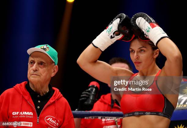Christina Hammer of Germany poses with coch Dimitros Kirnos before the WBC middleweight World Championship title fight at Westfalenhalle on April 1,...