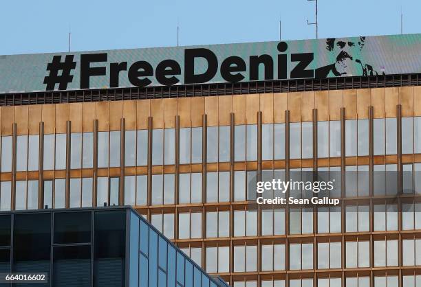 The hashtag of FreeDeniz is displayed above The Axel Springer building as it urges the release of German reporter Deniz Yucel being held in a Turkish...