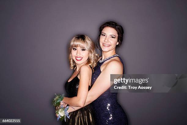 two girls at prom smiling in front of camera. - troy bond stock pictures, royalty-free photos & images