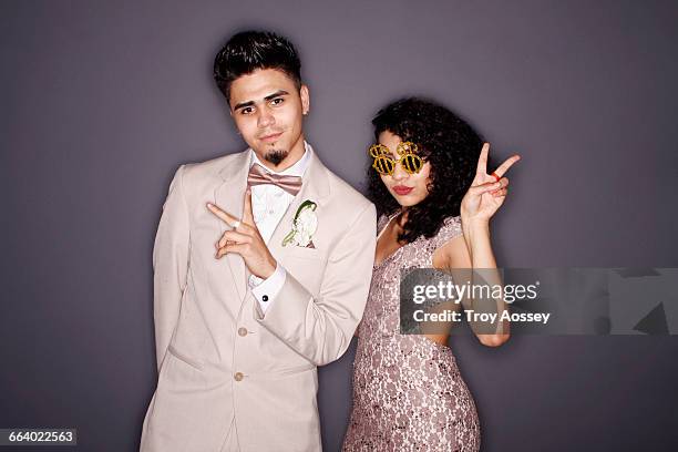 couple giving hand signals with funny glasses. - prom photo imagens e fotografias de stock