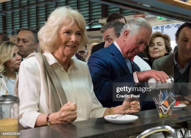 Prince Charles, Prince of Wales pours sugar into his coffee as Camilla, Duchess of Cornwall waits for her drink at the start their day with a coffee...