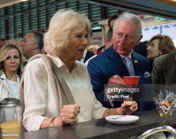 Prince Charles, Prince of Wales drinks his coffee as Camilla, Duchess of Cornwall waits for her drink at the start their day with a coffee at a...